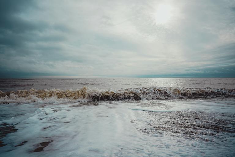 Wet cloudy coast washed by wave